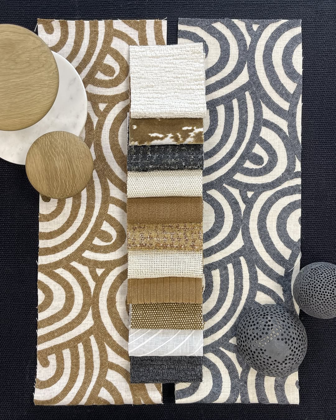 Patterned fabric samples for Roman shades in modern textures and colors displayed on a table.