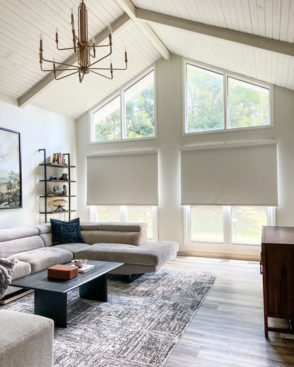 Solar shades on windows in a modern living room, offering UV protection and cordless design.