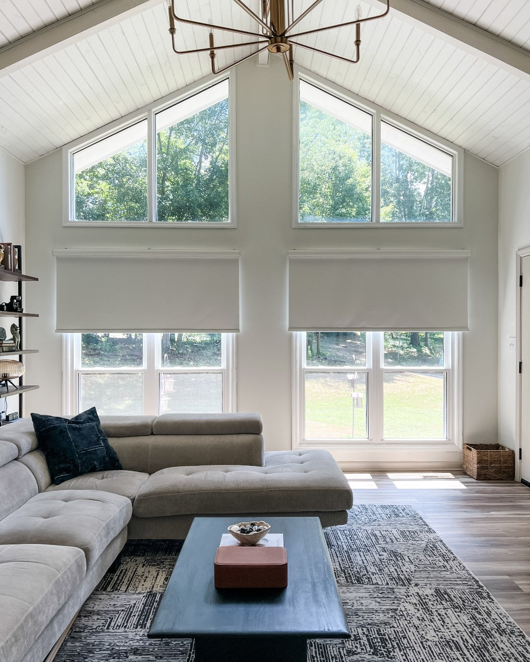 Solar shades in a modern living room, blocking sunlight, offering UV protection and privacy.