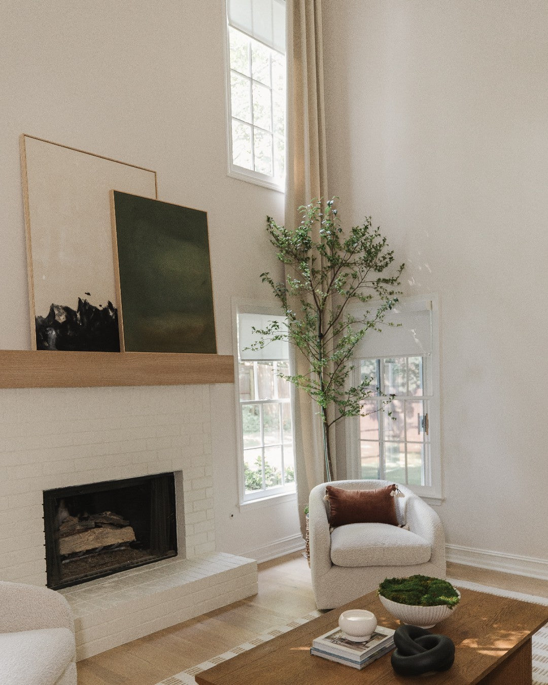 Modern living room with large windows featuring solar shades, contemporary decor, and natural light.