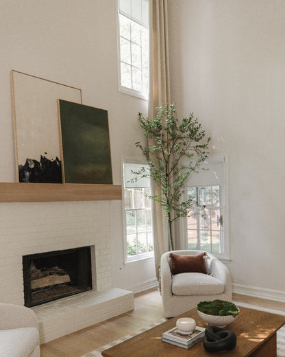 Modern living room with large windows featuring solar shades, contemporary decor, and natural light.