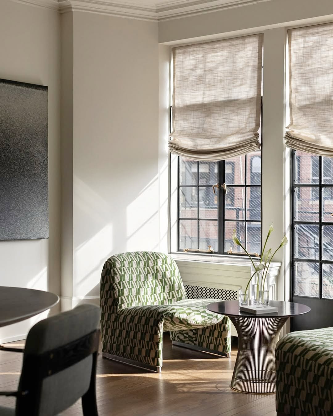 Modern living room with custom relaxed Roman shades in natural linen filtering soft light through large windows