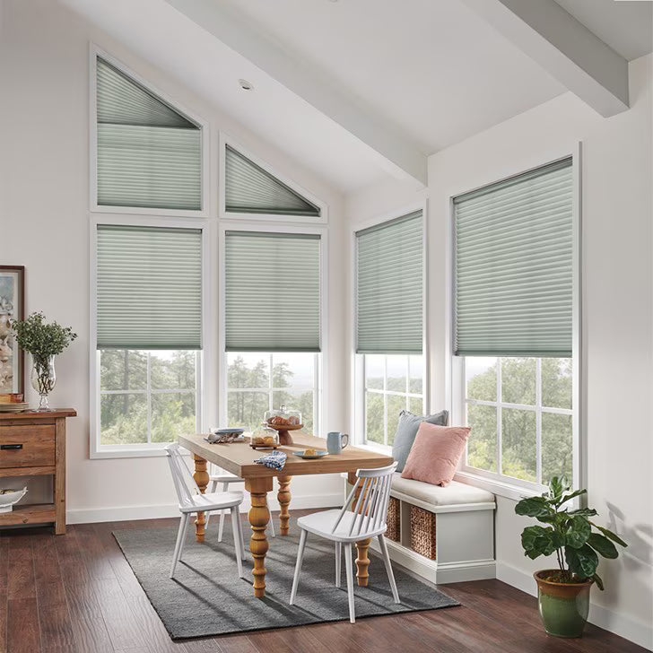 Custom honeycomb cellular shades with 1-inch cells fitted to arched and triangle-shaped windows
