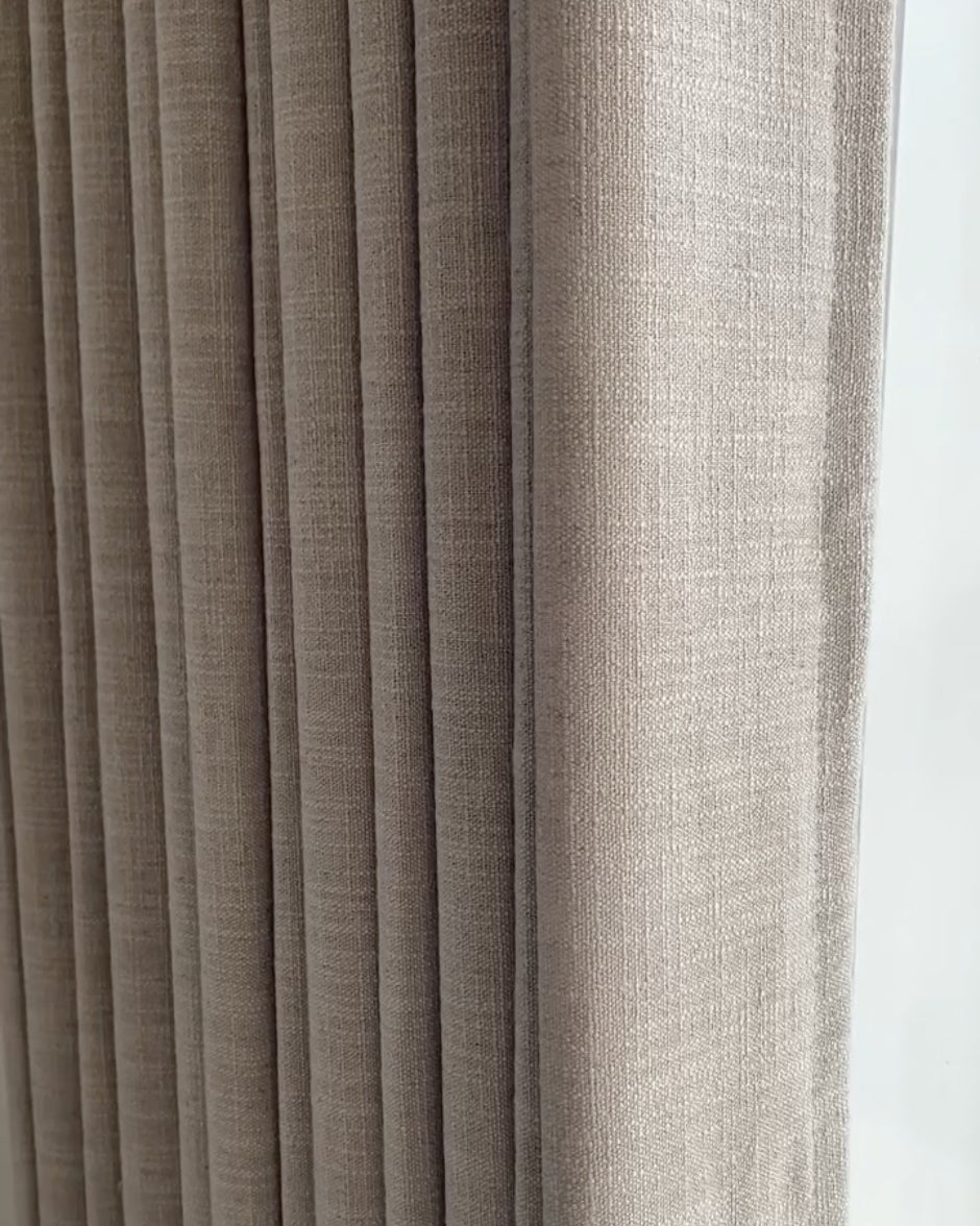 Linen blackout curtains in a natural hue, showcasing texture and style.