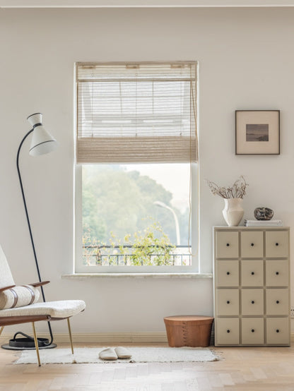 Natural linen bamboo shade with black stripes in minimalist room decor.