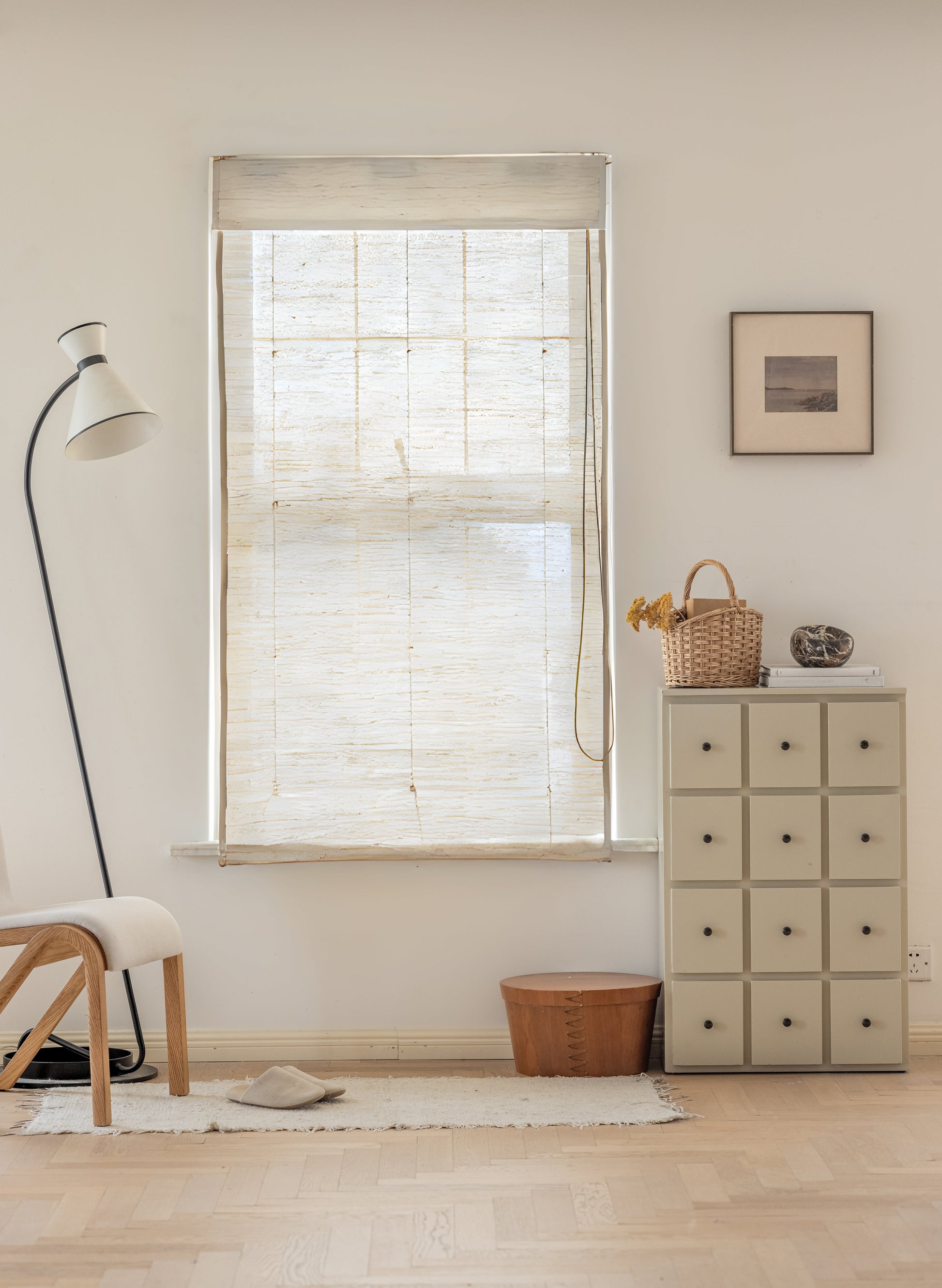 Natural ramie bamboo window shades in coconut white with delicate woven texture in a light neutral room setting