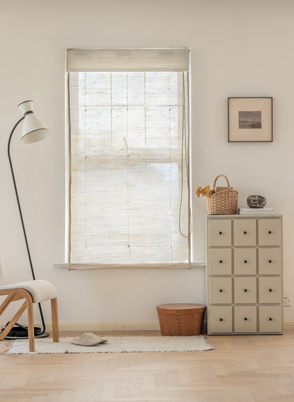 Natural ramie bamboo window shades in coconut white with delicate woven texture in a light neutral room setting