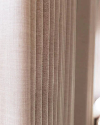 Close-up of beige pleated linen blend curtain showcasing texture and eco-friendly fabric in a modern home setting