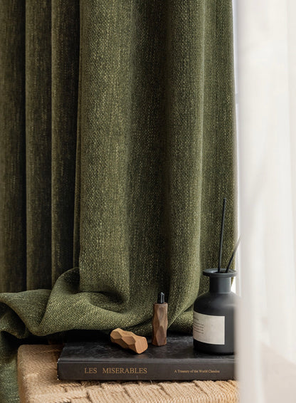 Luxury heavyweight green chenille curtains elegantly displayed with a LES MISERABLES book and scent diffuser, enhancing bedroom decor