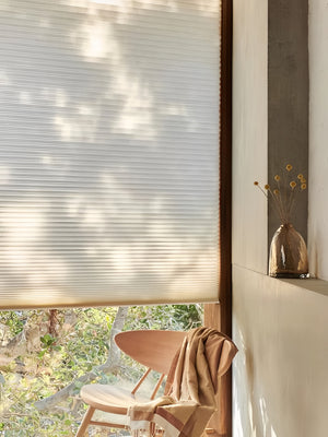 Cordless double cell honeycomb shades insulating a living room window