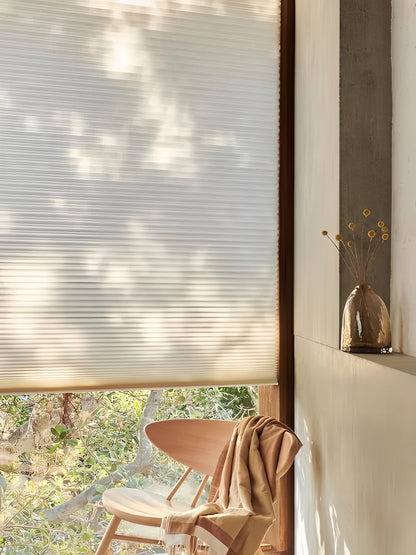 Cordless honeycomb blinds in mulberry silk finish, home interior setting with natural light.