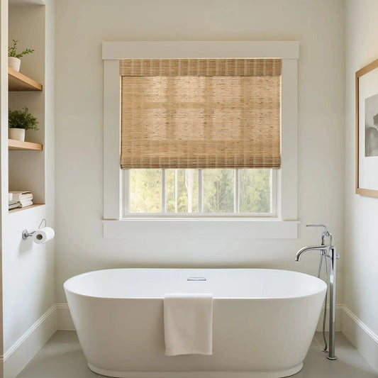 Bathroom with white bathtub and natural honey-colored ramie woven shades on window