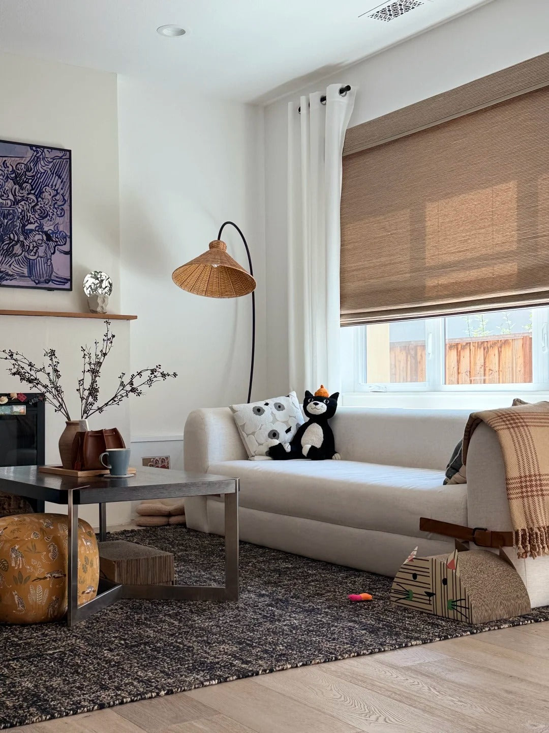 Cozy living room with light-filtering bamboo roman shades on window and modern decor