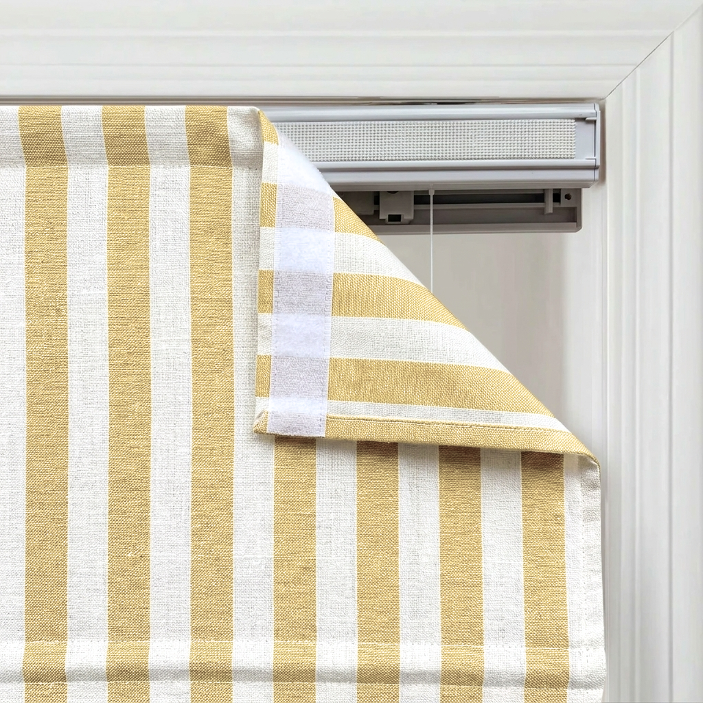 Butter yellow striped linen Roman window shades brightening a modern living space