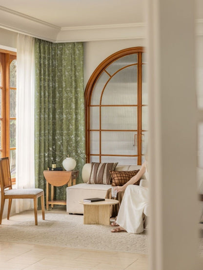 Elegant green jacquard curtain with ginkgo leaf pattern in a cozy living room setting