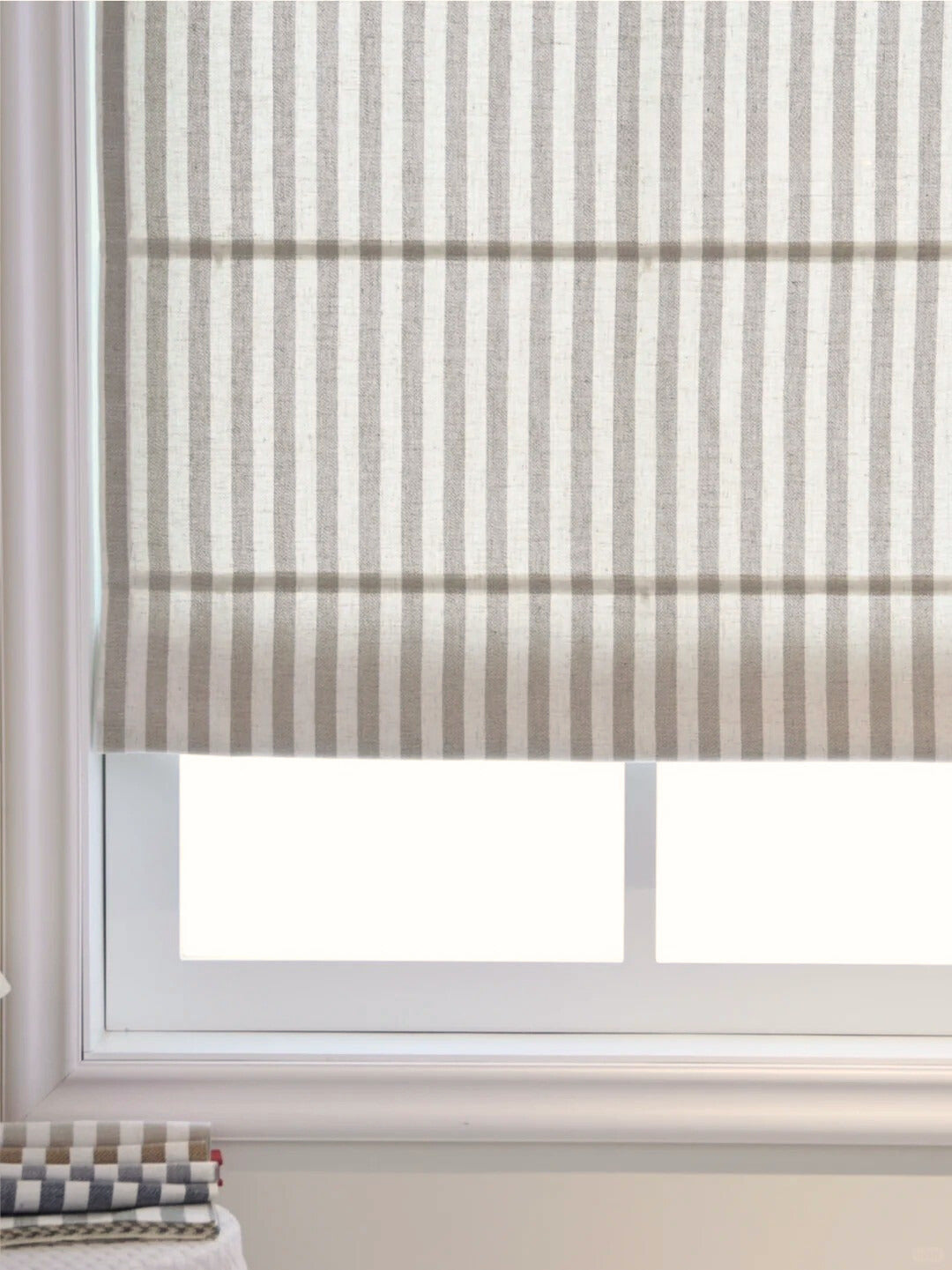 Classic striped roman shades with cordless lift, light filtering and blackout options on window