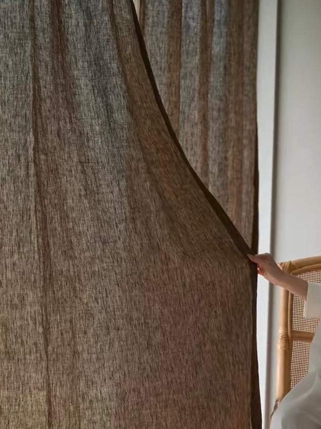 Coffee brown linen curtains with a sheer, loosely woven texture and warm earthy color, gently filtering light