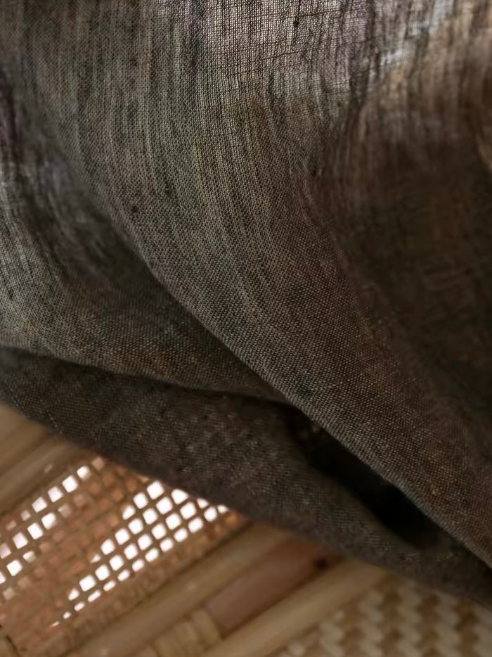 Coffee brown linen curtains in sheer woven fabric, showing a natural slubbed texture and softly draped folds