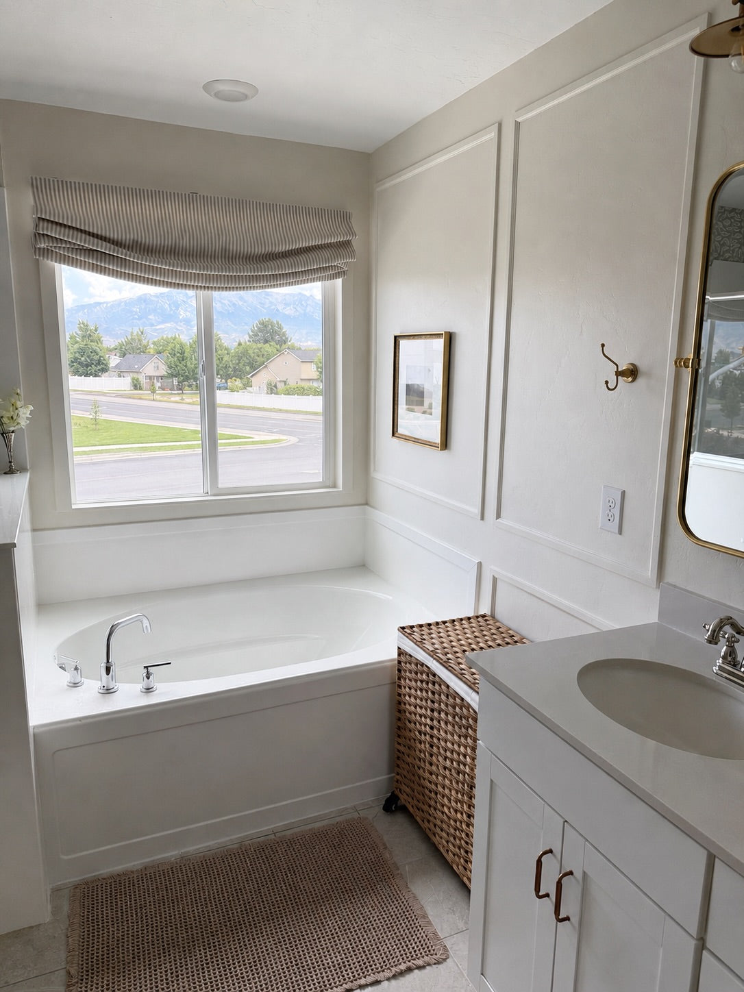 Custom cordless relaxed roman shades with soft curved bottom in modern living room setting