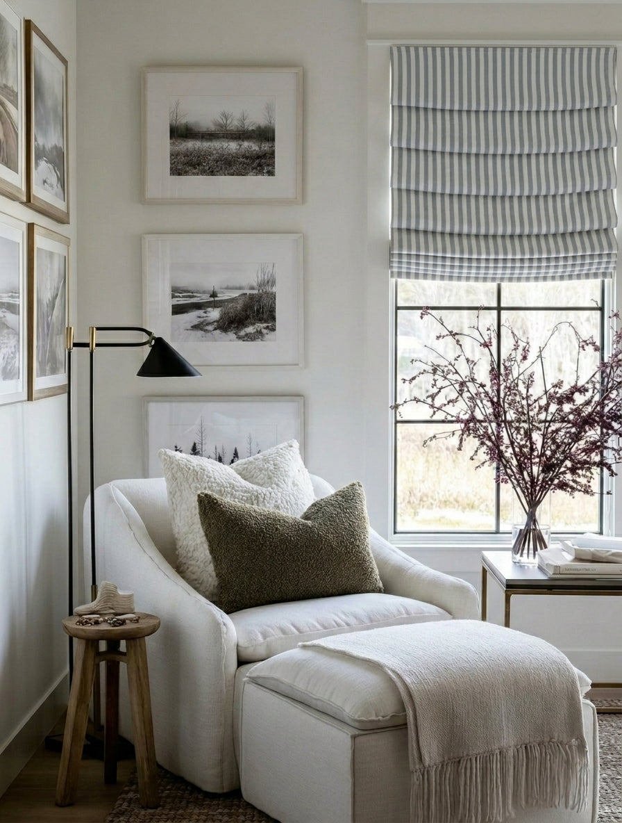 custom hobbled roman shades in blue and white striped fabric with soft cascading folds covering a window