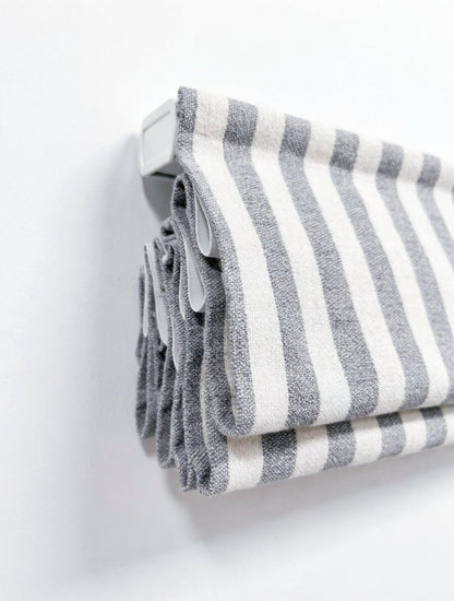 Custom hobbled roman shades in gray and white striped fabric with textured cascading folds and a waterfall top