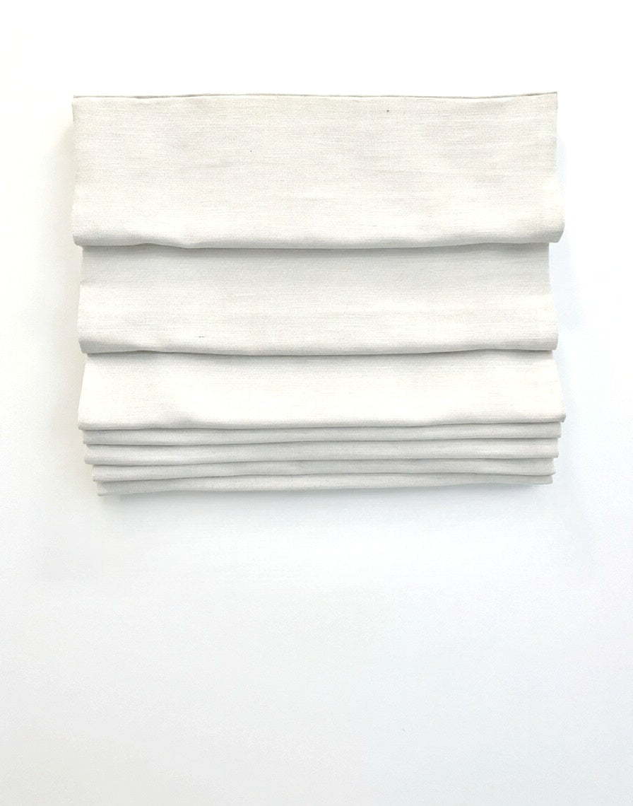 custom hobbled roman shades in ivory linen-blend fabric with soft, cascading layered folds and a textured finish