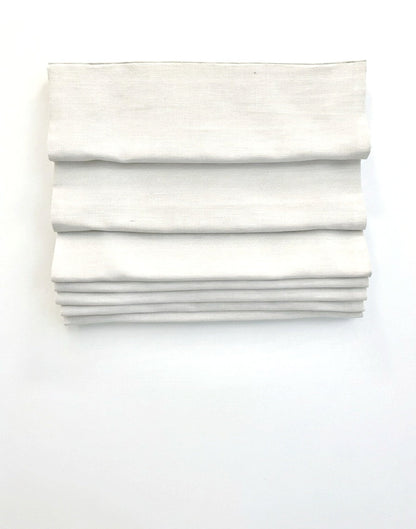 custom hobbled roman shades in ivory linen-blend fabric with soft, cascading layered folds and a textured finish