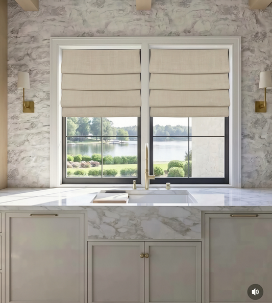custom hobbled roman shades in beige linen-blend fabric with soft, layered horizontal folds across two windows