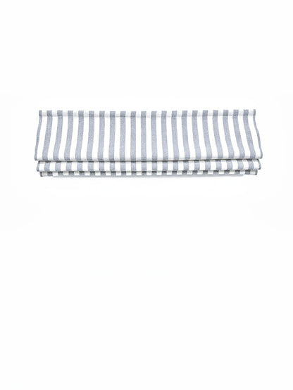 custom hobbled roman shades in white linen-blend fabric with blue-gray vertical stripes and soft layered folds