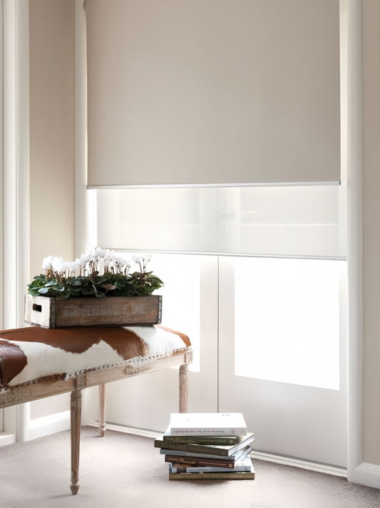 Double roller blinds with cordless dual roller system for bedroom light control, featuring sheer and blackout layers in slim headrail