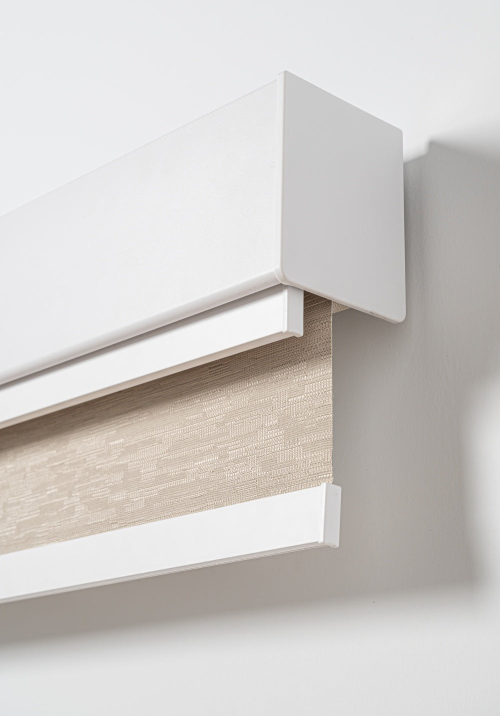 Double roller blinds with sheer and blackout layers in slim headrail for bedroom light control