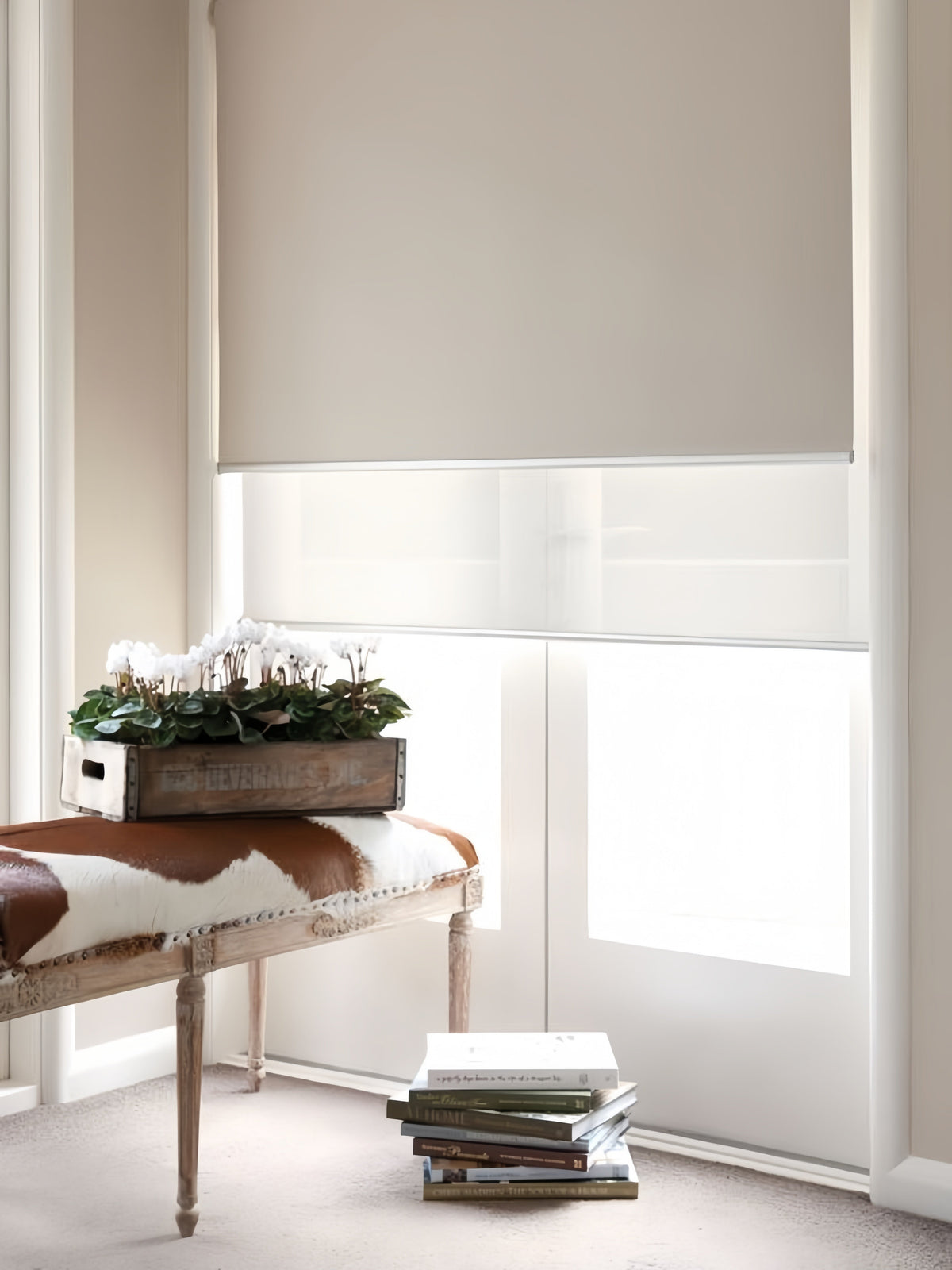Double roller blinds with cordless dual roller system for bedroom light control, featuring sheer and blackout layers in slim headrail