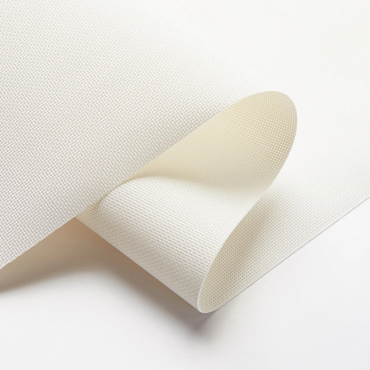 Close-up of white textured solar shade fabric demonstrating UV protection and light filtering capabilities