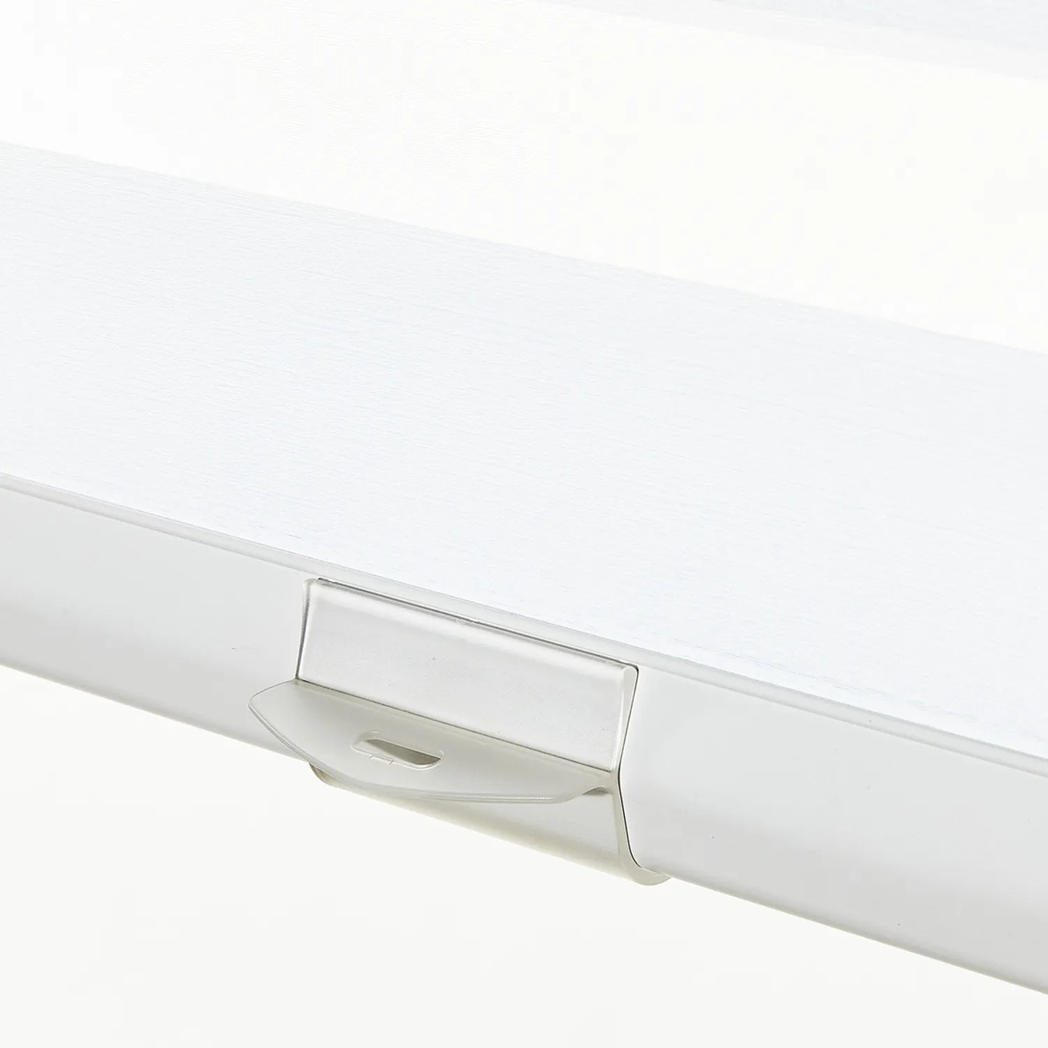 Close-up of white cordless zebra roller shade with transparent handle, demonstrating innovative, kid-safe design and premium polyester material