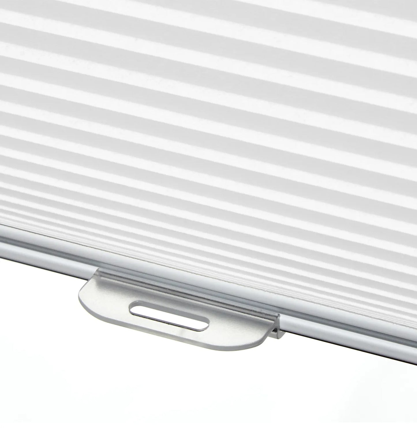 Close-up of cordless honeycomb blind shade in white with detailed view of easy-lift handle for seamless adjustment