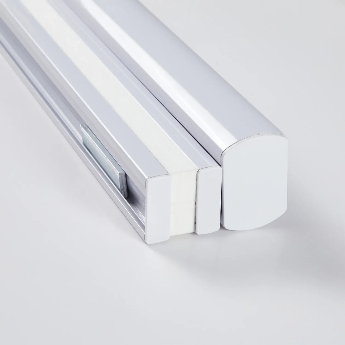 Close-up of cordless top-down bottom-up honeycomb shade mechanism in white and chrome finish for eco-friendly window treatments