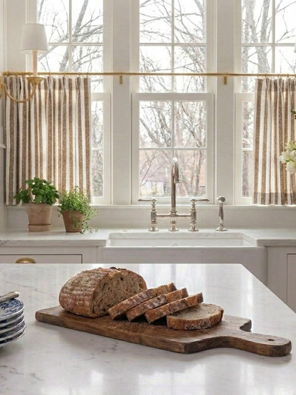 Classic striped linen café curtains in French country style on a kitchen window, custom-made for perfect fit and easy hanging
