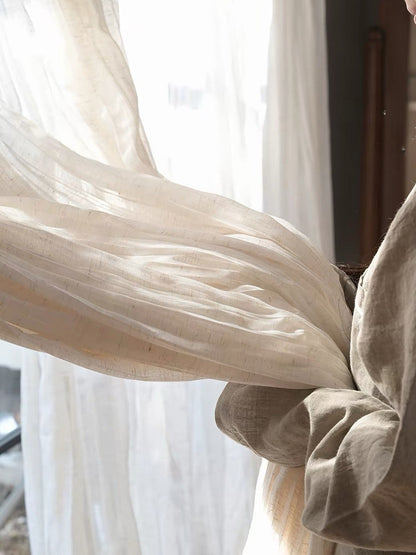 Gauze curtains in a sheer ivory linen blend, with a lightweight drape and soft, irregular crinkles.