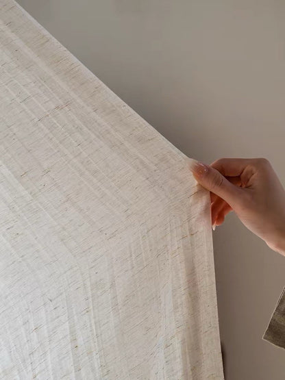 Gauze curtains in a pale natural linen-blend fabric, with a lightweight drape and fine, irregular crinkled texture.