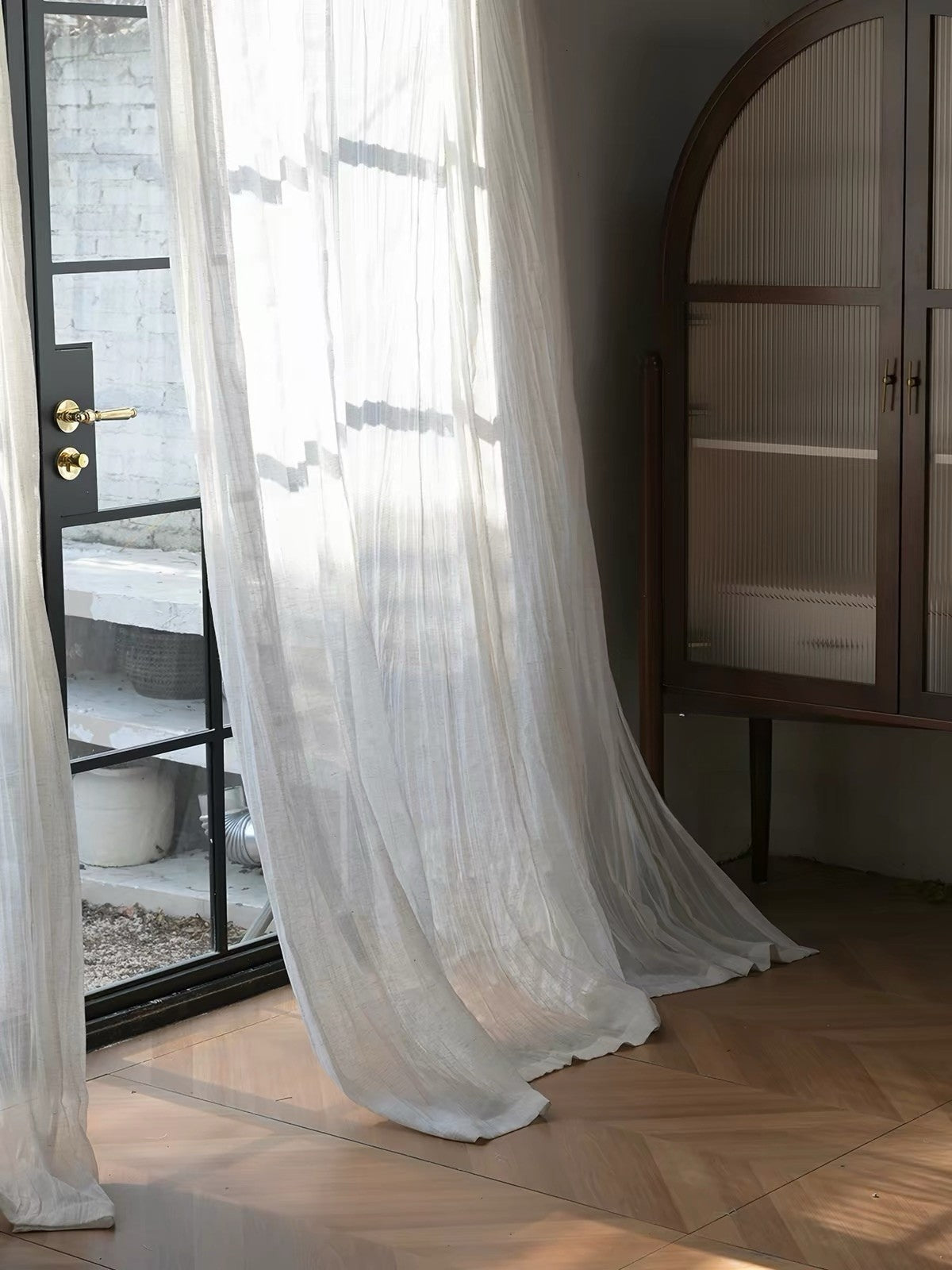Gauze curtains in sheer white linen-blend fabric, with fine texture and soft, irregular crinkles for an airy drape.