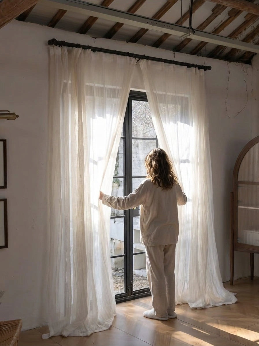 Gauze curtains in soft ivory, lightweight semi-sheer linen blend with relaxed crinkled waves and a gathered header.