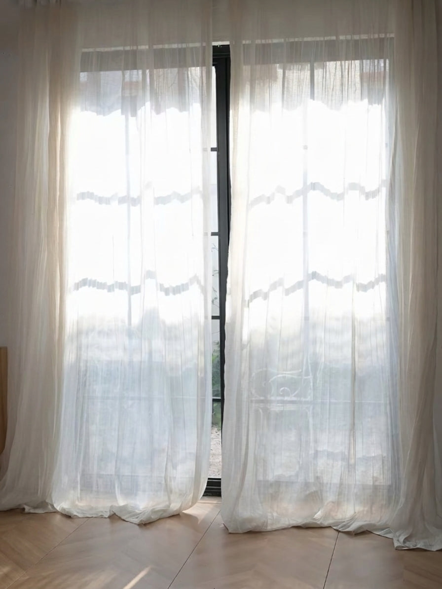 Gauze curtains in sheer white linen-blend fabric with a softly crinkled texture and flowing floor-length panels.