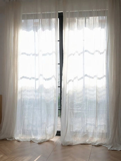 Gauze curtains in sheer white linen-blend fabric with a softly crinkled texture and flowing floor-length panels.