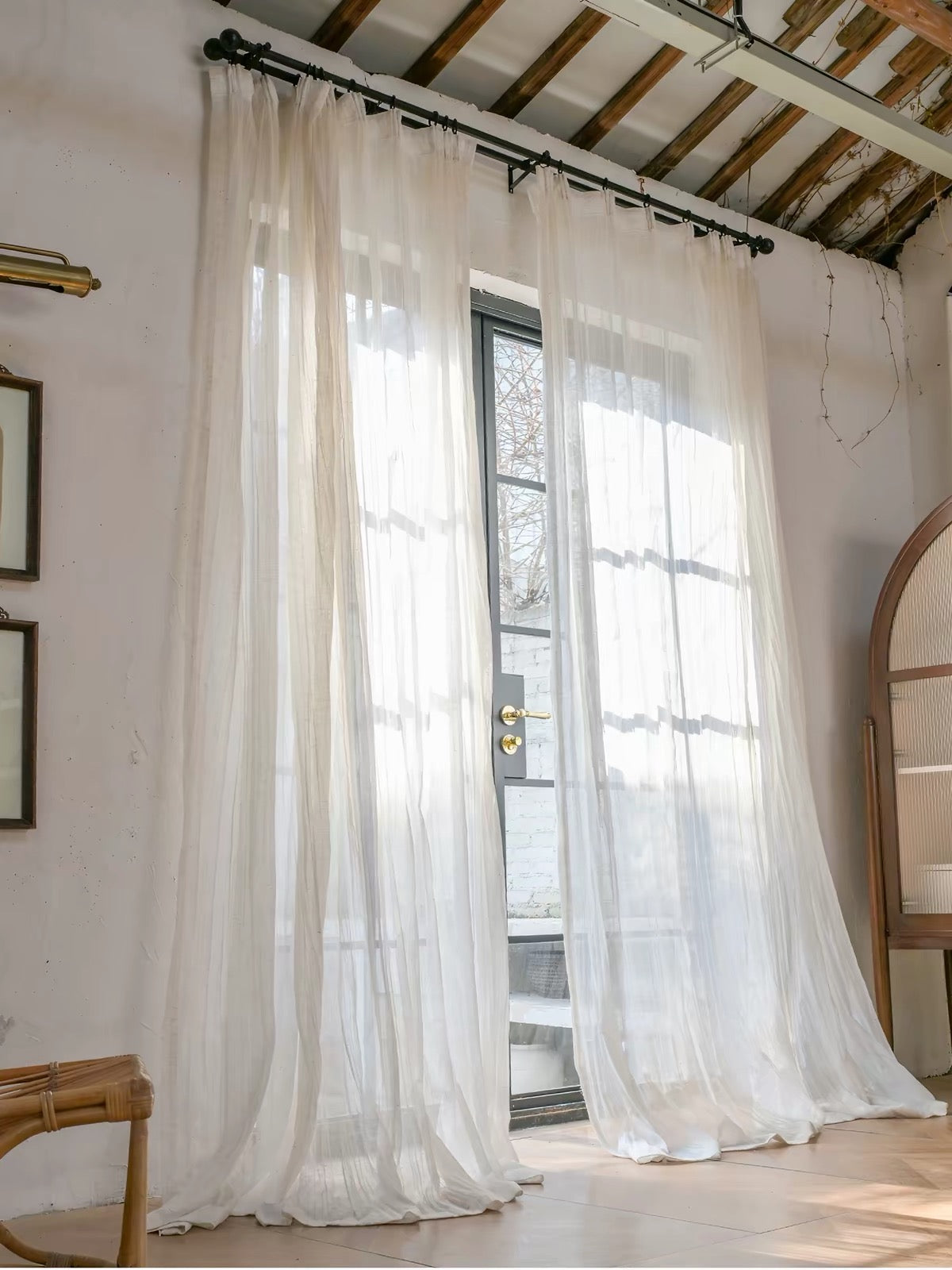 Gauze curtains in sheer ivory fabric with a lightweight drape, soft crinkles, and a fine, subtly textured surface.