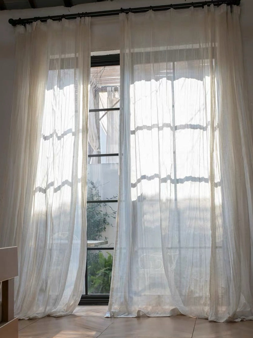 Gauze curtains in sheer ivory linen-blend fabric, with a lightweight drape and soft, irregular crinkled texture.