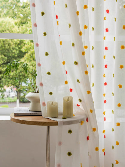 Colorful kids curtains with sheer fabric and playful rainbow pom-pom trim for bright children's rooms