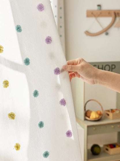 Colorful kids curtains with sheer fabric and rainbow pom-pom trim for bright, playful rooms