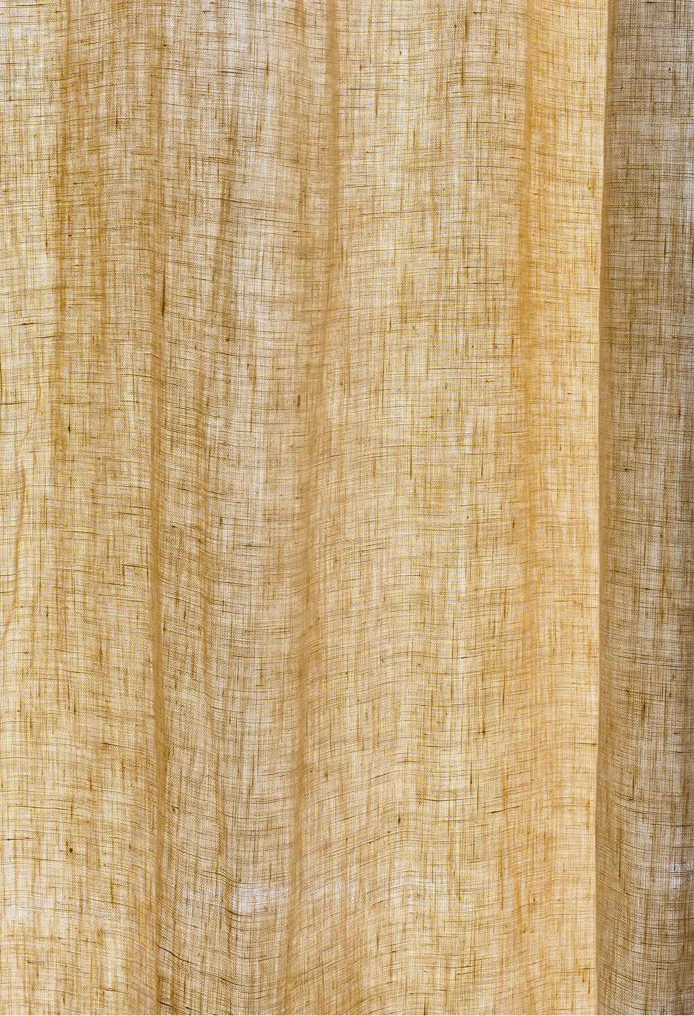 Mustard yellow curtains made of 100% French linen with a soft, muted texture and natural elegance.