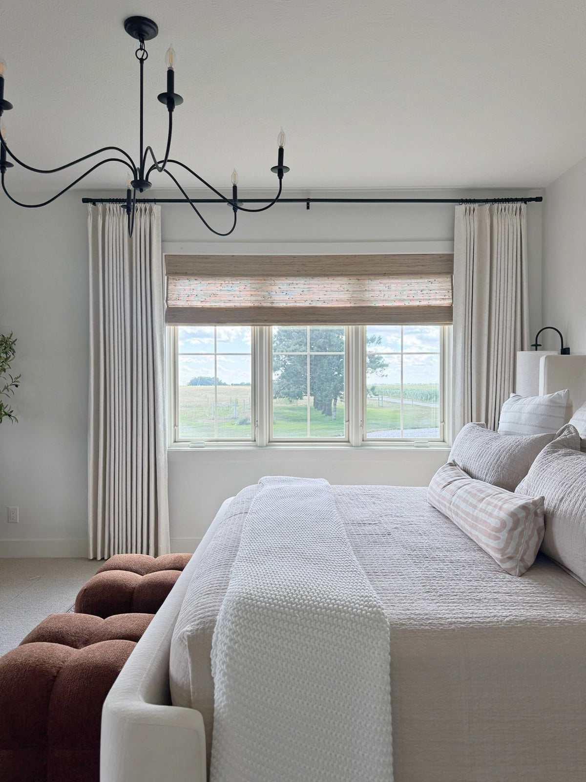 Natural Ramie Bamboo Roman Shades in beige, with a finely woven texture and a flat Roman-style fold across the window
