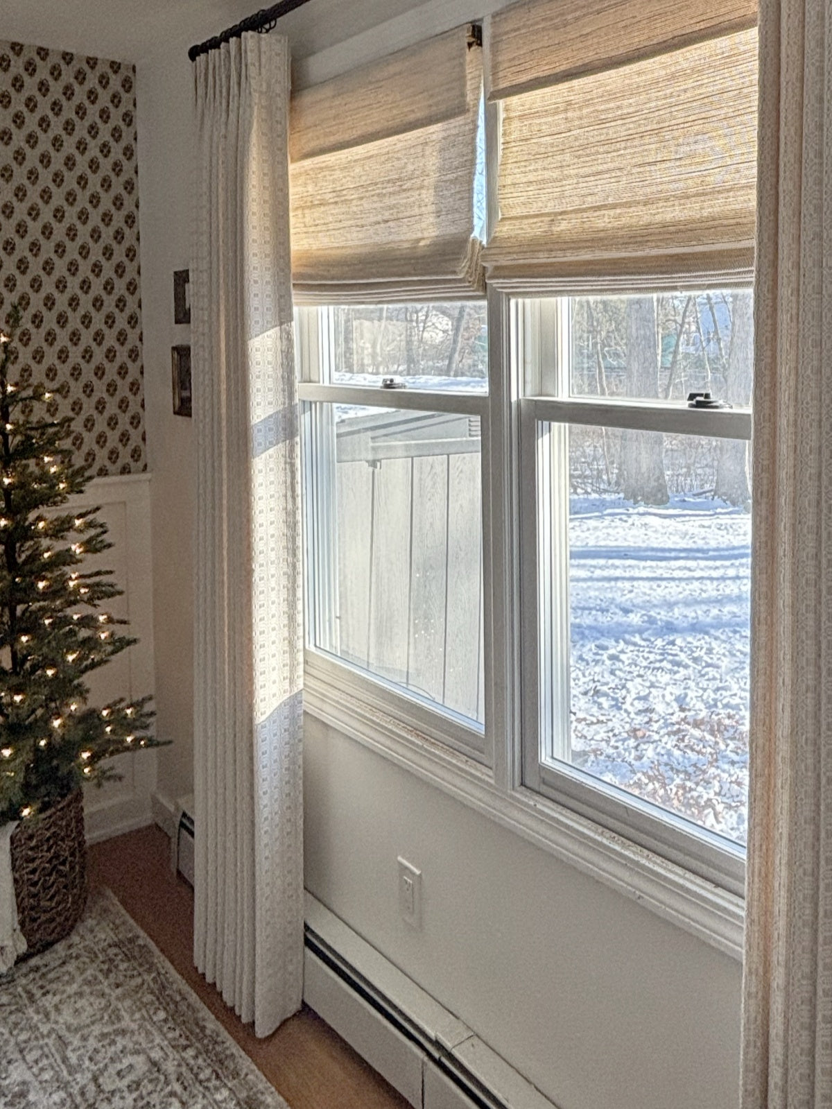 Natural Ramie Bamboo Roman Shades in beige woven natural fibers, featuring a textured surface and neatly folded top stacks.
